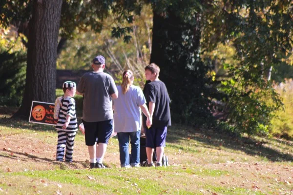 A white child trick-or-treating in Ferguson in a prisoner costume.