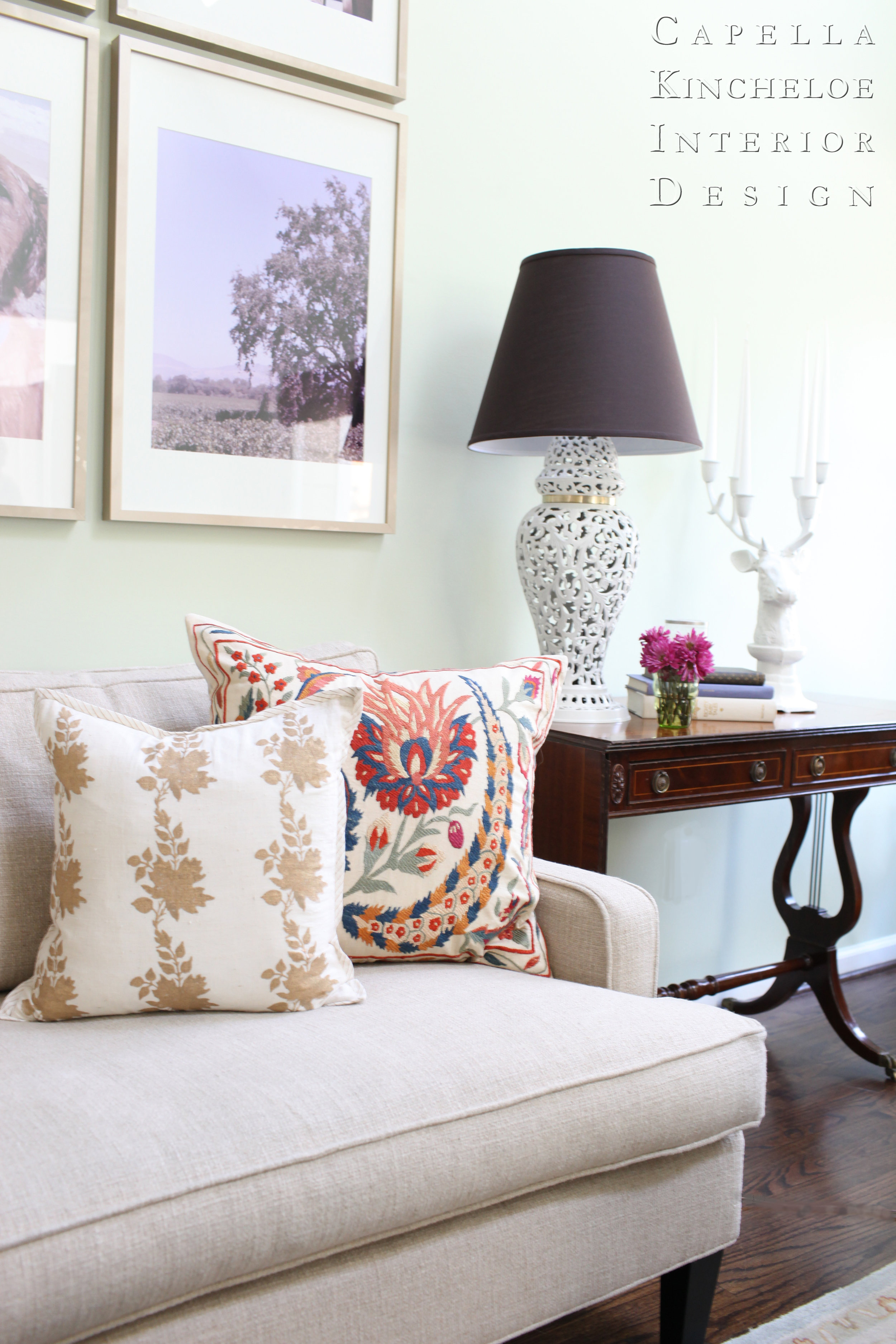 southern living room, suzani pillow, mint walls, custom photo art, black lamp shade
