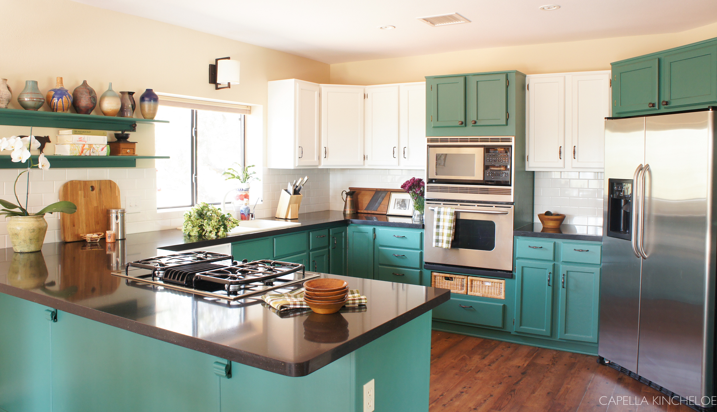 two tone cabinets, green kitchen cabinets, stainless steel appliances, black quartz counters open shelving 