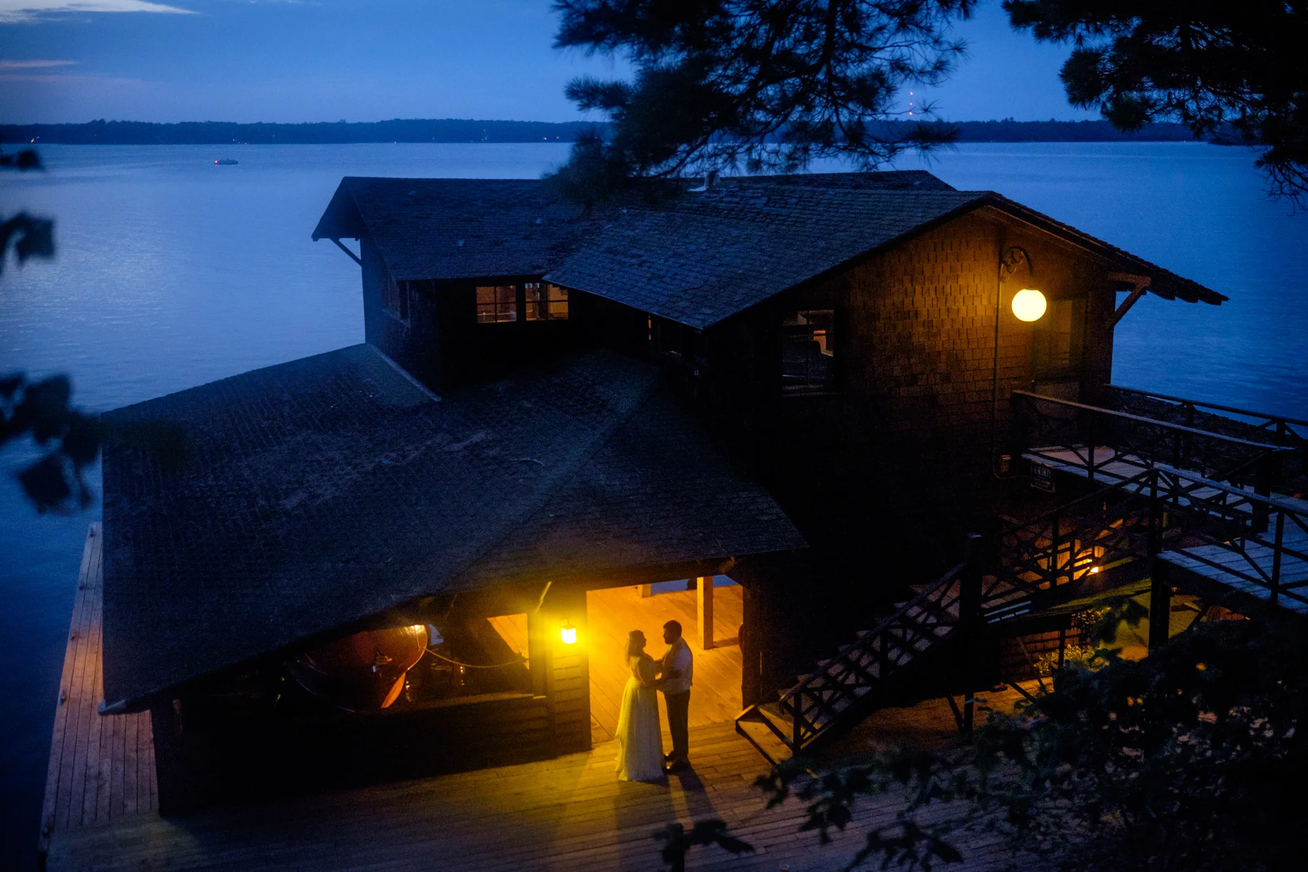 Boathouse wedding nighttime portrait.