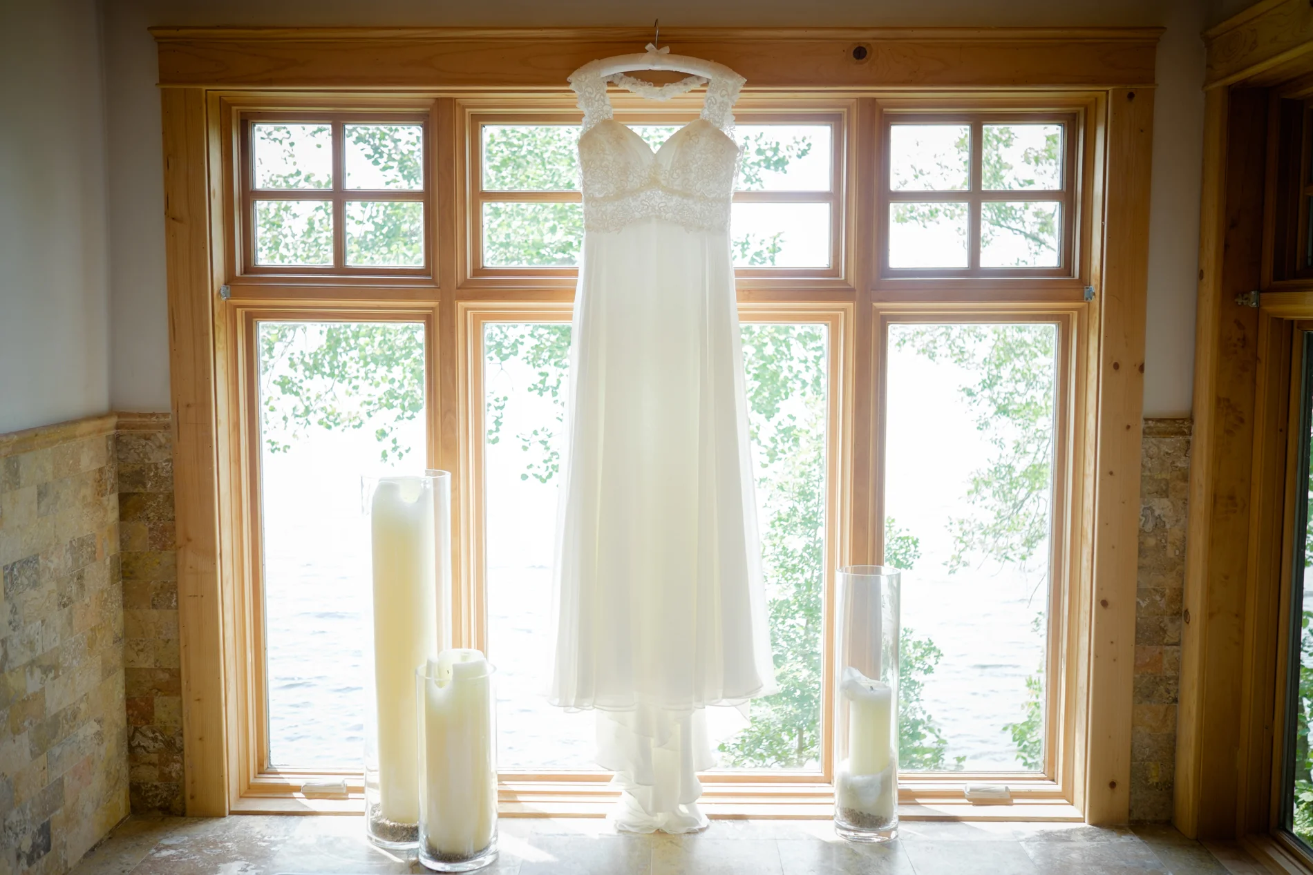 Wedding dress hanging in a window, Stout's Island Shore Lodge 3