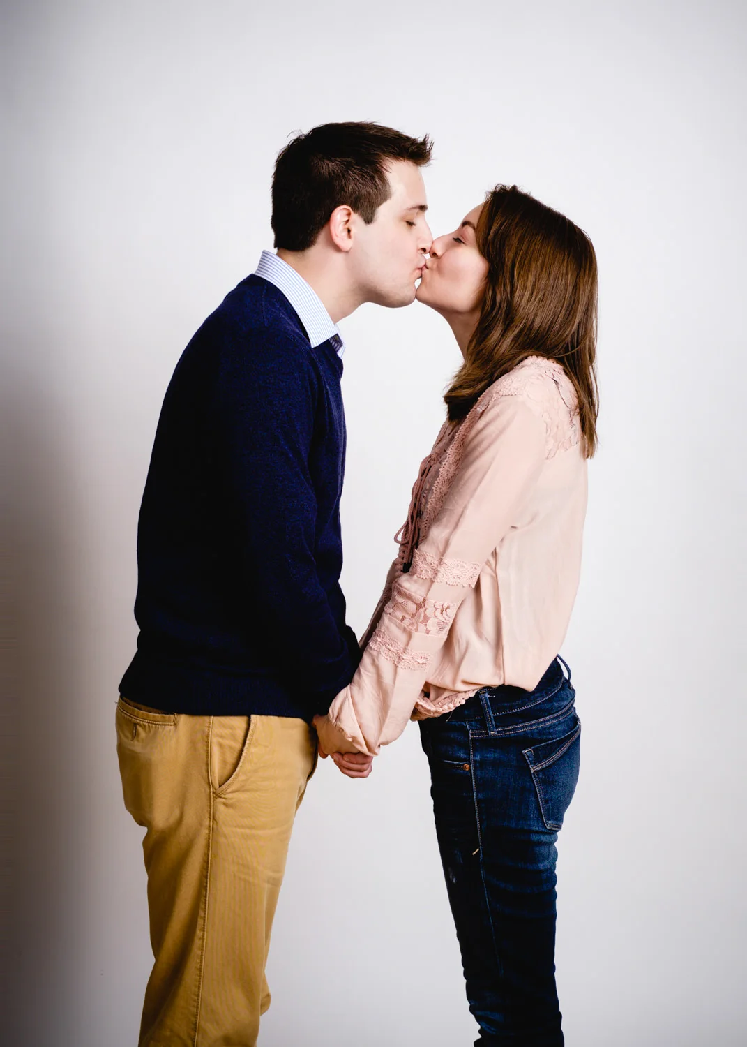 Studio engagement portriats couple kissing.