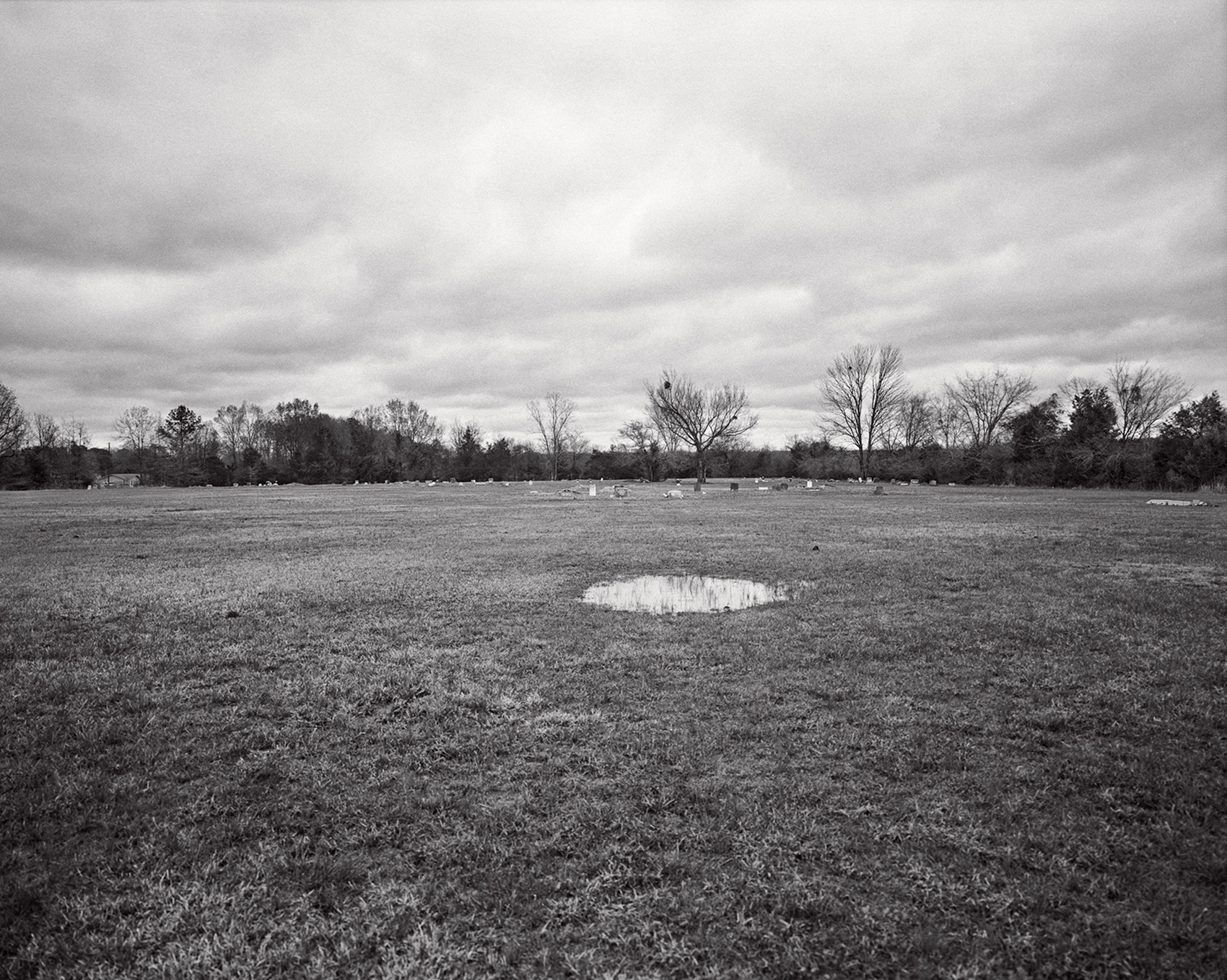 charlie brewer, kennedy's father, is buried in this cemetery in back of their family church.