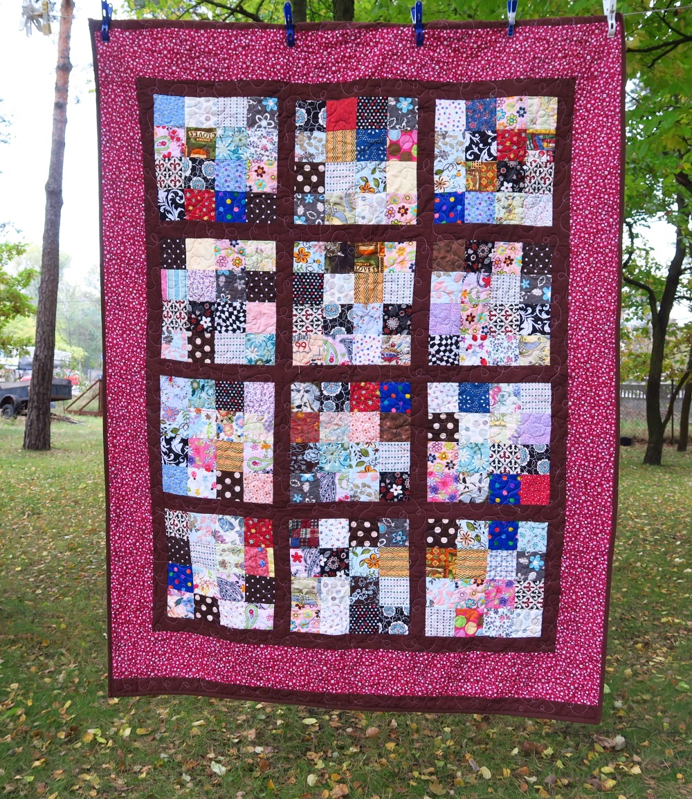 92 Misc. squares sashed in brown and bordered in a burgundy