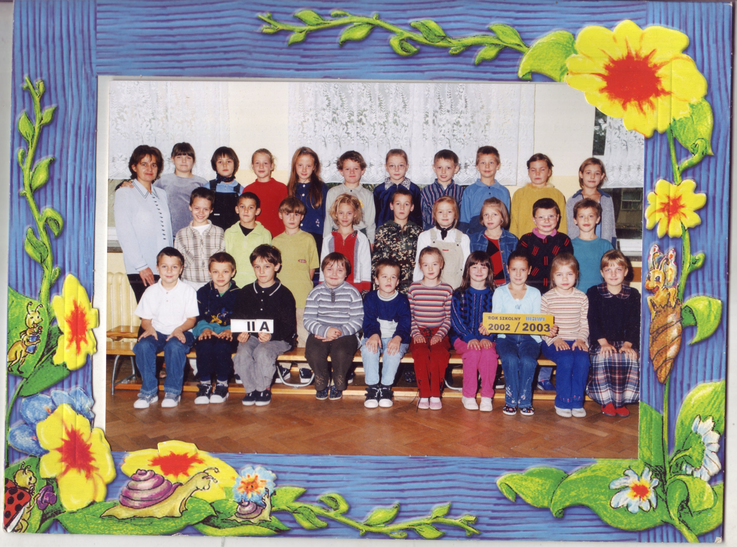 This is my daughter Lydia's second grade class picture. She's in the front row in the blue sweater/hot pink pants.