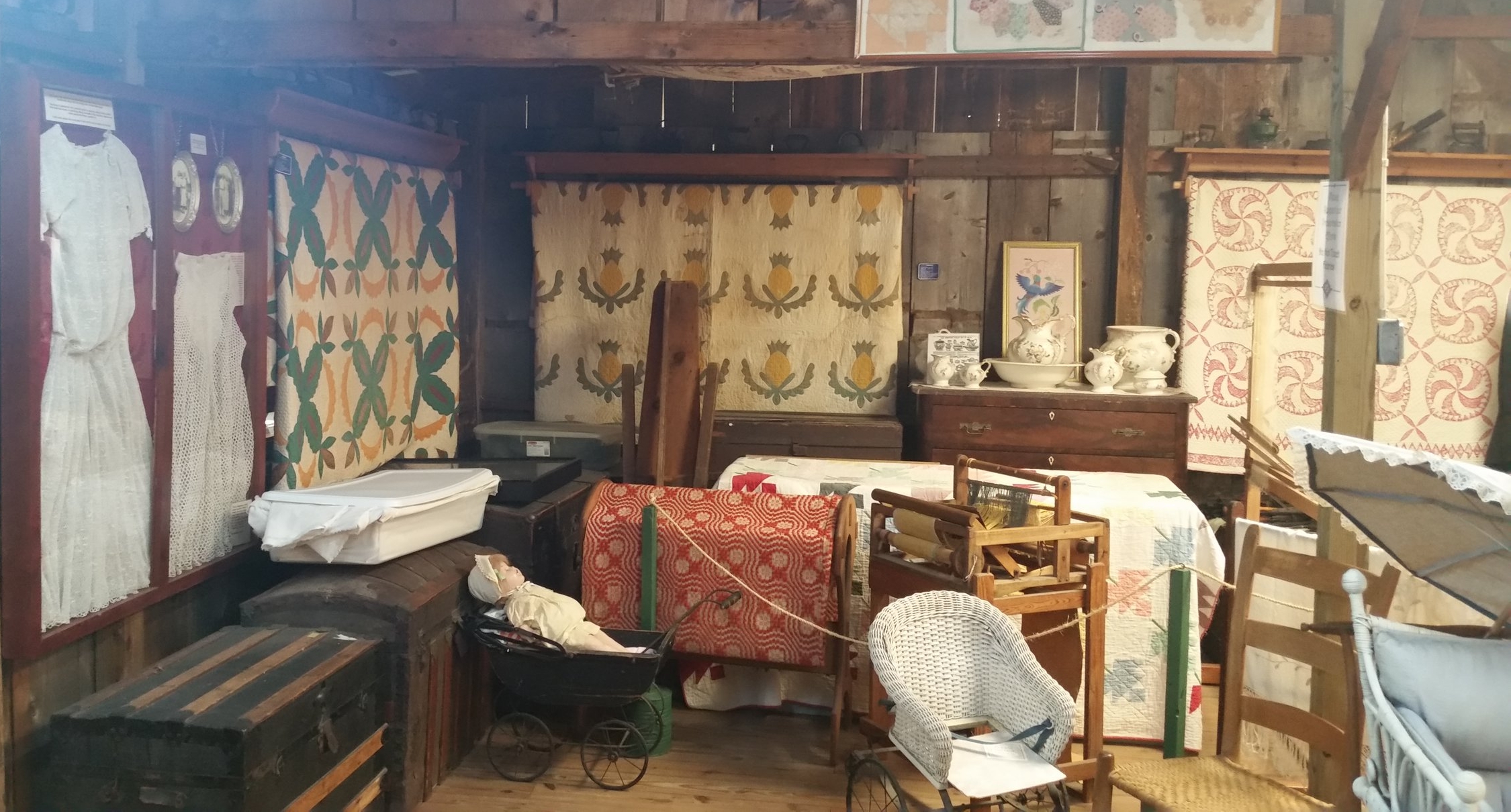When you walk in, this is the view to your left. I couldn't get close enough to the pineapple quilt to find the date, but it was super old.
