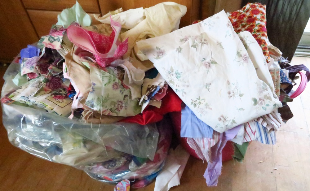 This is my most immediate goal. I'm going to try to get rid of the pile that is located int he pink plastic laundry tub by tomorrow night, midnight. The rather large piece of printed fabric is leftover from the latest quilt top I've finished but not written about yet.