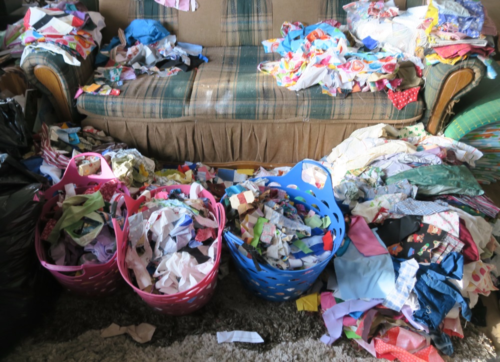 This is actually the living room. For a change, I left the table and sat on the sofa to sort. I had to decide/sort the scraps/strips that were all jumbled up together and crumbs. What a mess!