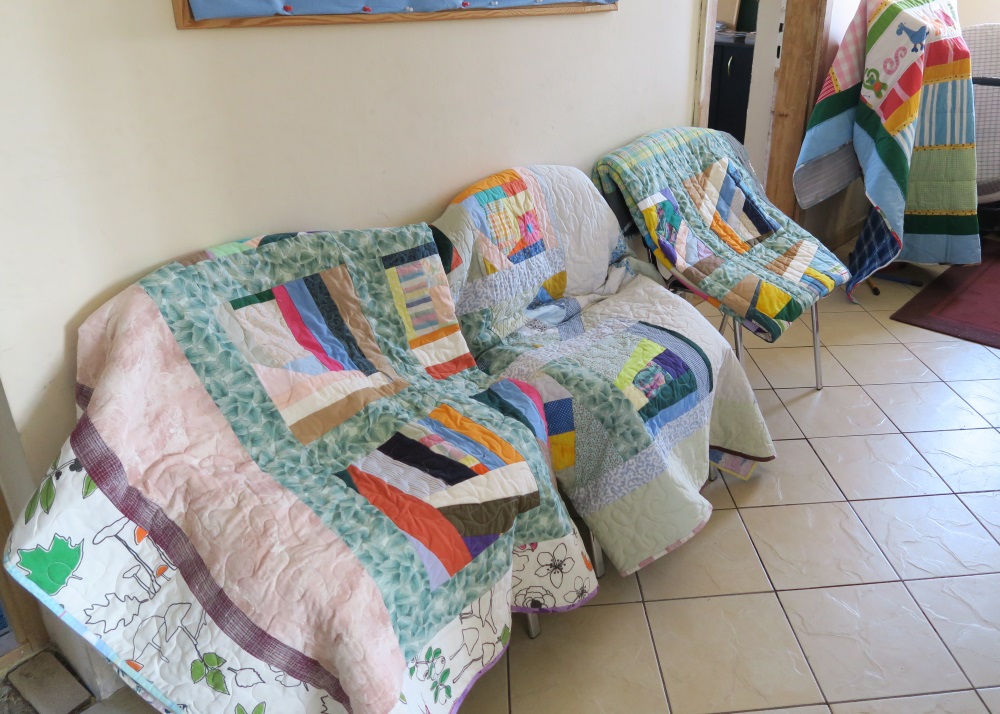 We put chairs in the entrance way and draped quilts over them so people would walk past quilts all the way into the main building.