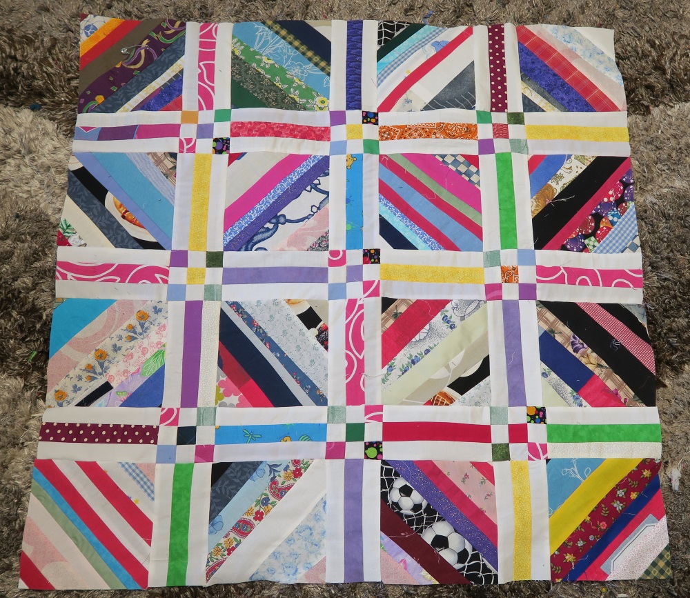 I have a lot of light strings - and to be honest, saturated colors make this more interesting. However, I decided to brighten it up by using brights for the sashing and 9 patches