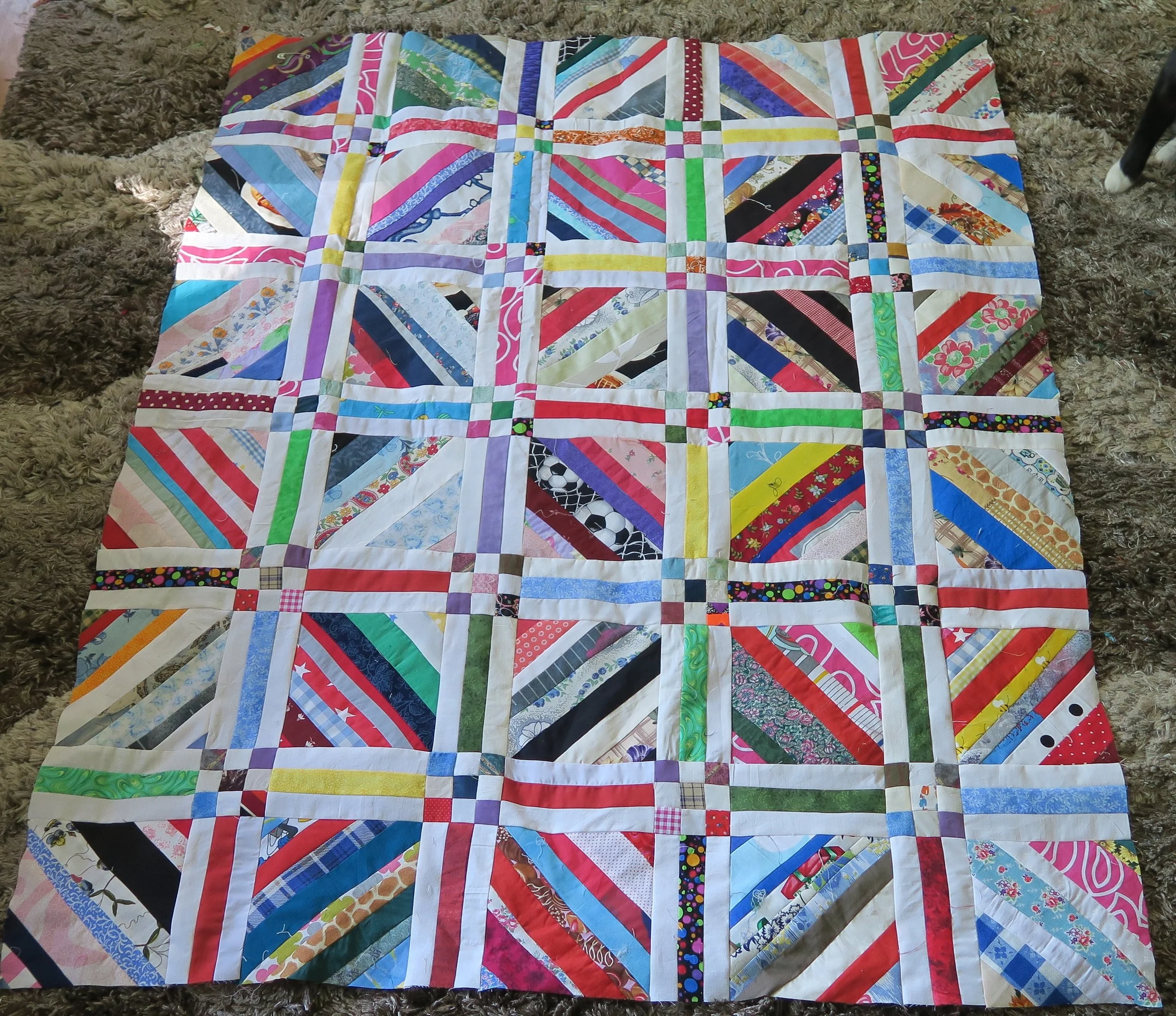 It is now about 42"x52" and a nice baby quilt size. :) But that's NOT the size I want to make. I have 50 of the 6.5" blocks made and I figure I need 100. There are only 30 of them in this top as of this picture. I'll need to make some more 9 patches and sashing pieces.