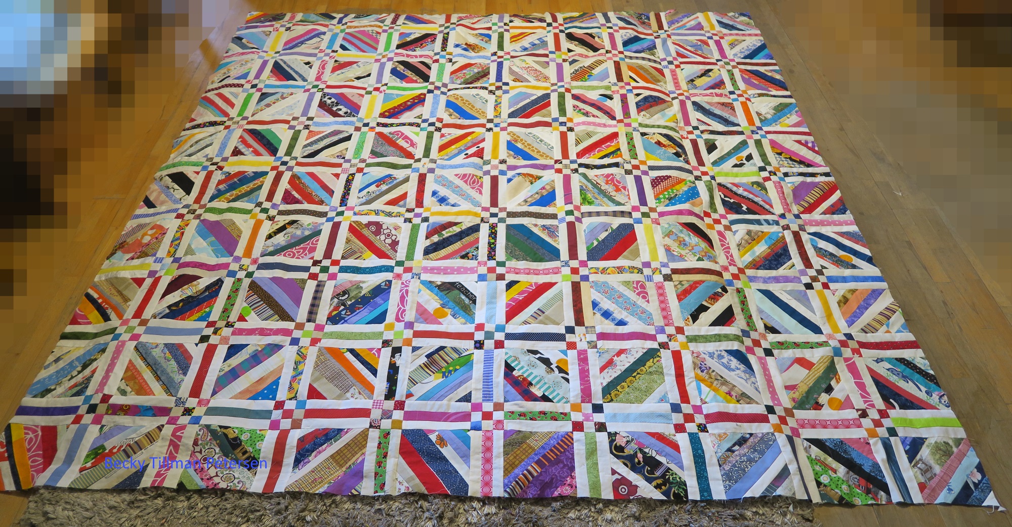 This is what it looked like before I added the outer sashing/cornerstones and last 1.5" cut white border which should make the whole top 'float' inside the binding.