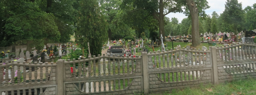 A typical Catholic cemetery. They are also almost all fenced in.