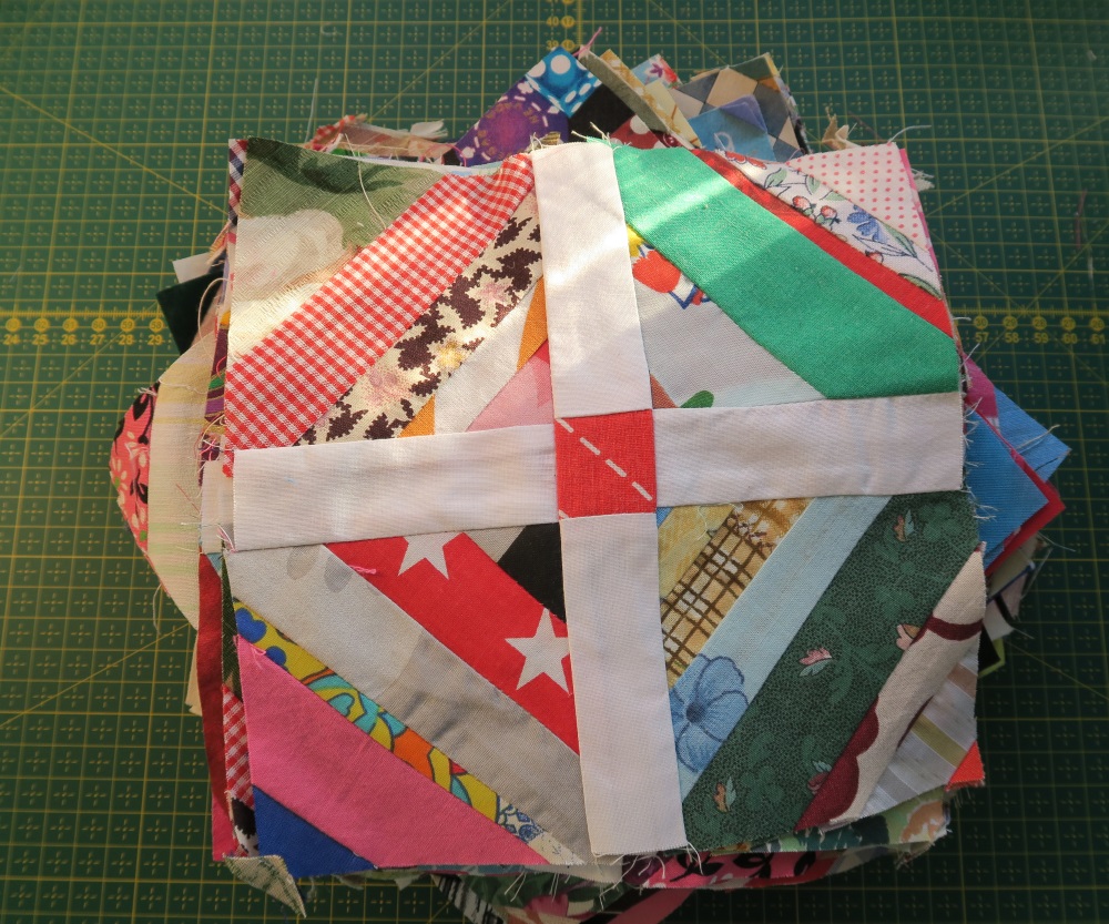 They are currently 7.5". Ready to be put together with the other blocks I have yet to make. Each one of the little string blocks started at 3.5" and the white strips are 1.5"x3.5" cut. The center cornerstone is a 1.5"x1.5" square.