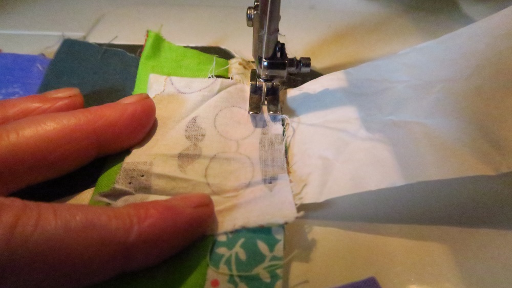Add a new scrap to the top of the previous piece. Flip it over. Do it again. And again. And again. Today I only did about 3 feet of scraps.