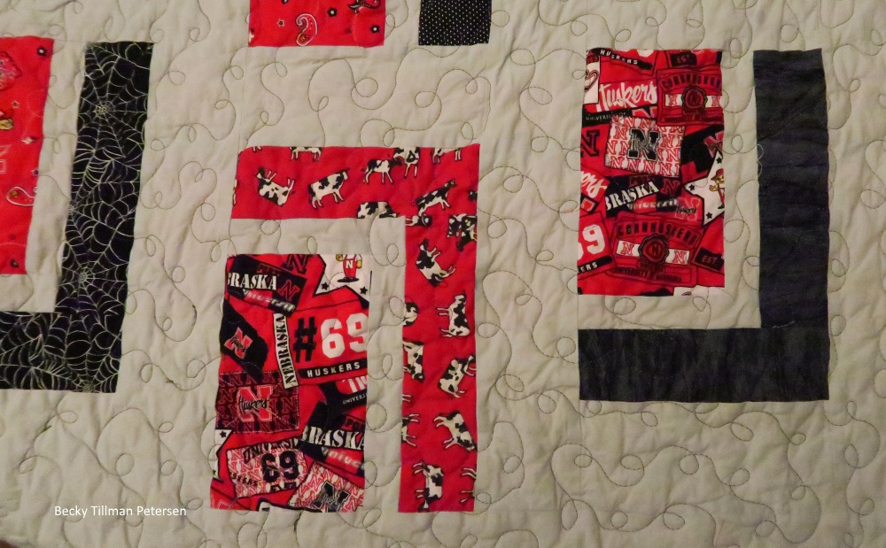 The cows fabric surrounding one of the fabrics I had. I used up every possible inch of it in this quilt (that larger Huskers print. I was really kicking myself that I hadn't bought at least a yard. Lesson learned.