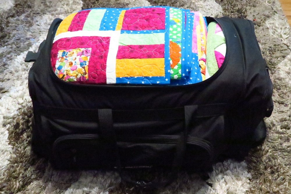 After. 11 quilts in that bag - though only 6 are "bigg-ish" - 3 twin, 1 full and 2 queen. Three are commonly called lap quilt size with only one a baby quilt size.