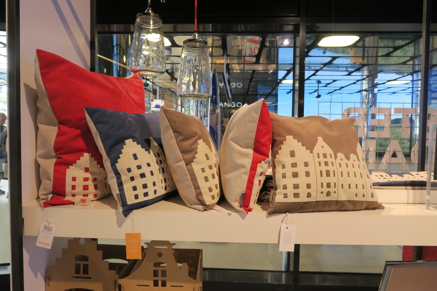 Obviously I wasn't looking in the right spot, but these were about the only "soft" items I saw. Pillows - that looked like Amsterdam. I looked at them closely and these pieces must have been glued on as there was no stitching around that applique part. The applique was some sort of a rubbery feeling type fabric - not a cotton, so probably not so easy to sew.