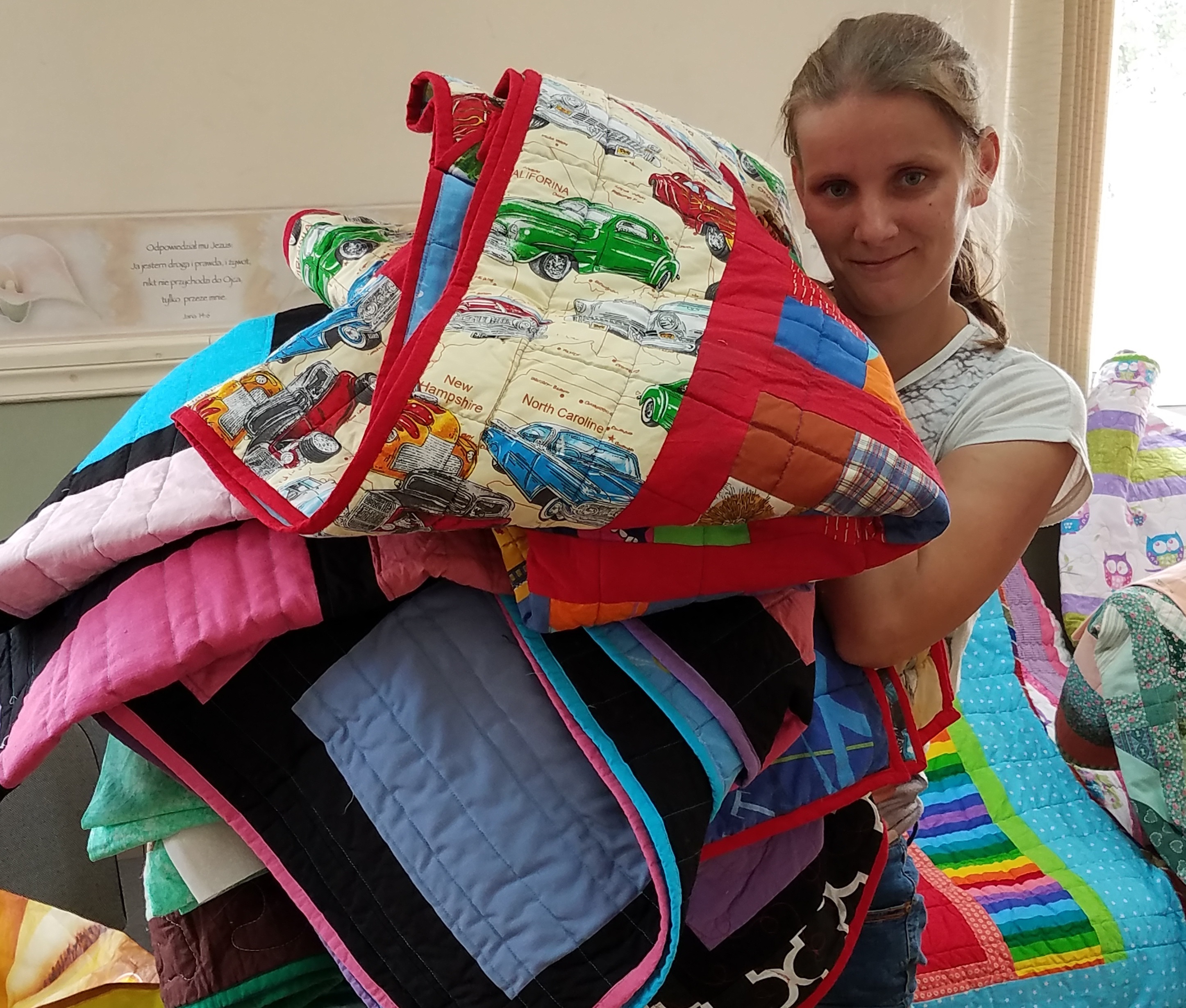 This lady needed 7 quilts and was happy to pose. She was excited to get these beautiful quilts!