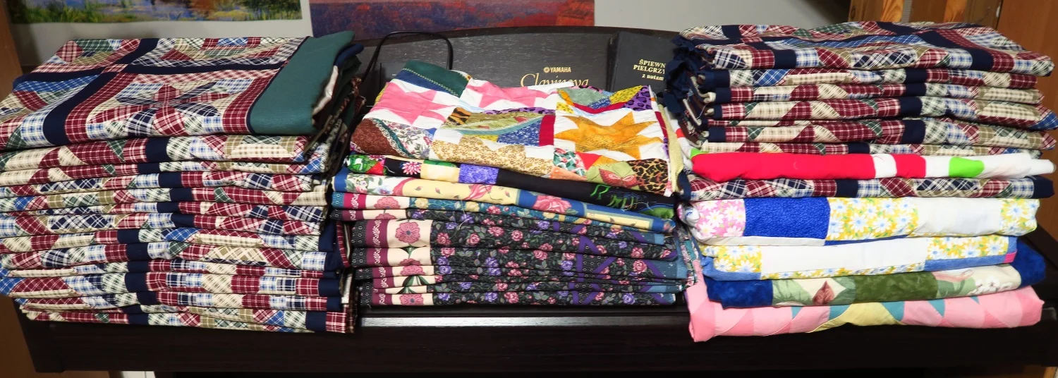 These are the tops I'm ready to finish up as charity quilts. Four of these tops were donated as tops--The rest were panels or cheater sections that she brought from the QT headquarters and we added borders. One was a small middle of a quilt (the bright stars in the middle of the pictures) was pretty but too small - so Rachael added borders to it. There are 38 here.