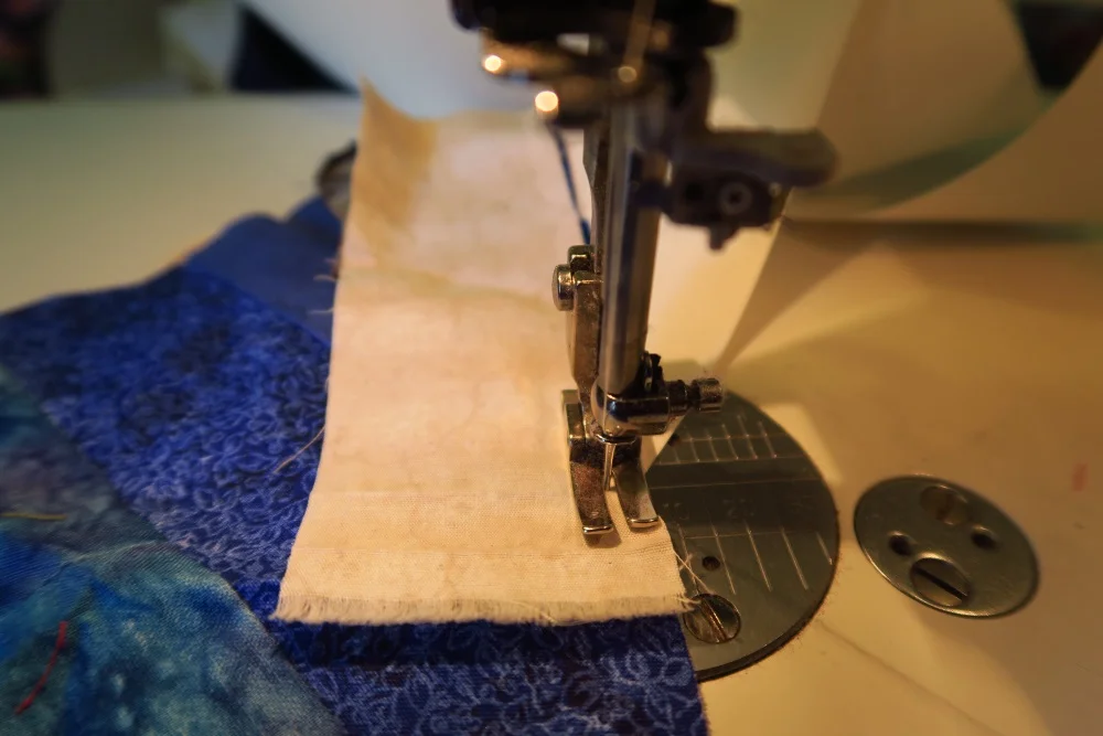 Sew down the pale piece on top of the blue. 