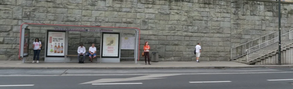 Because we were going so fast, we had a hard time getting bus stops that were crowded with people - they were blurry - so here's one where just a few people are waiting.