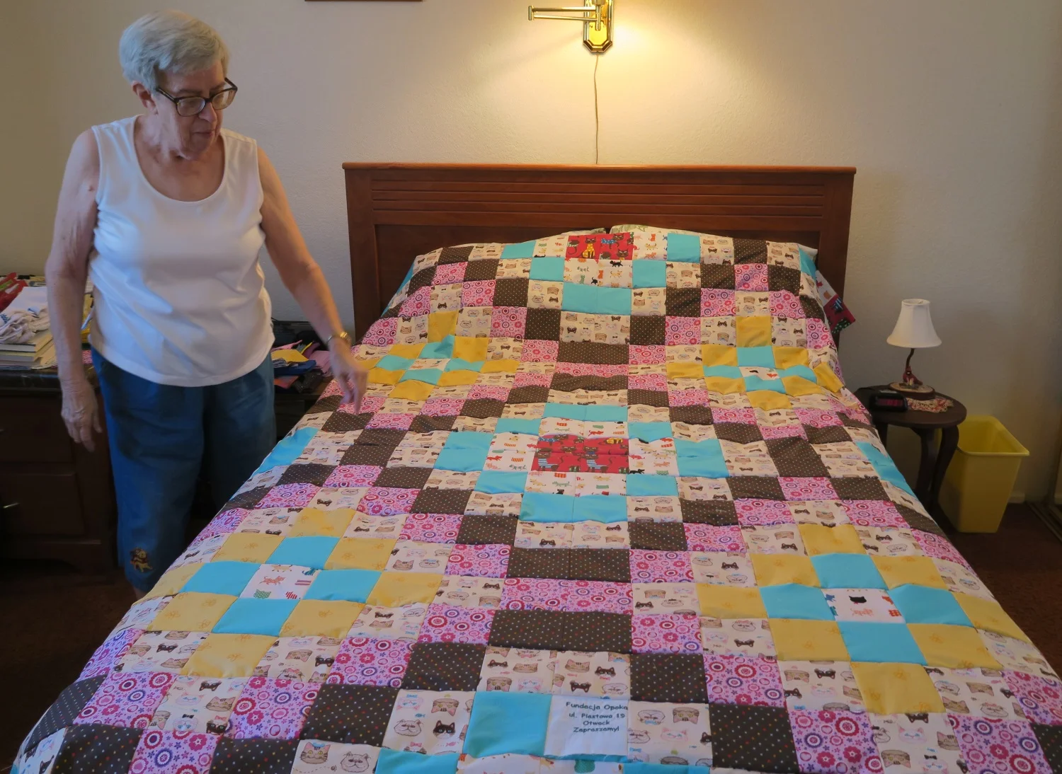 The big quilt top is made up of four smaller Around the World designs put together into one large top. It is draped over her guest bed to show me. She packs them in a box as she finishes them and then when the box is full, she ships it to me!