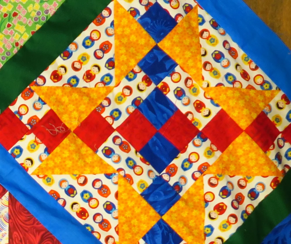 The background fabric is made up of mini Russian stacking dolls or "matryoszka dolls".