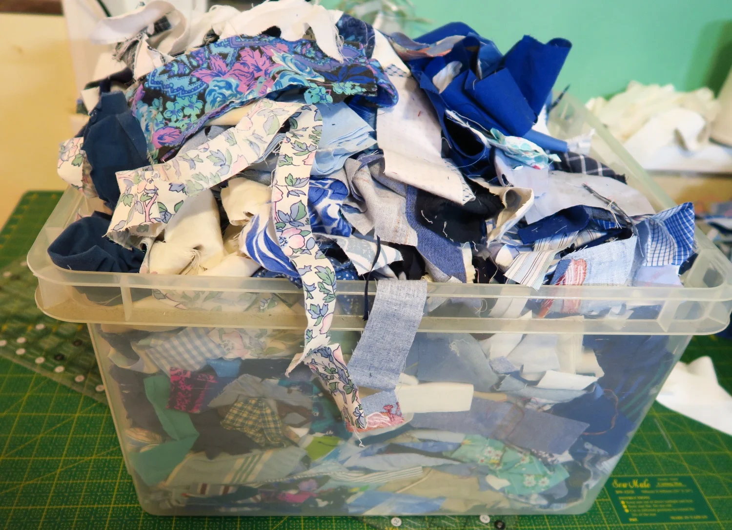 I may have been a little too generous while throwing the scraps into this bucket. But I was trying to keep them corralled. I may go back through the bucket and actually cut out 2 1/2" squares from these scraps as I am using that size for the next quilt top.