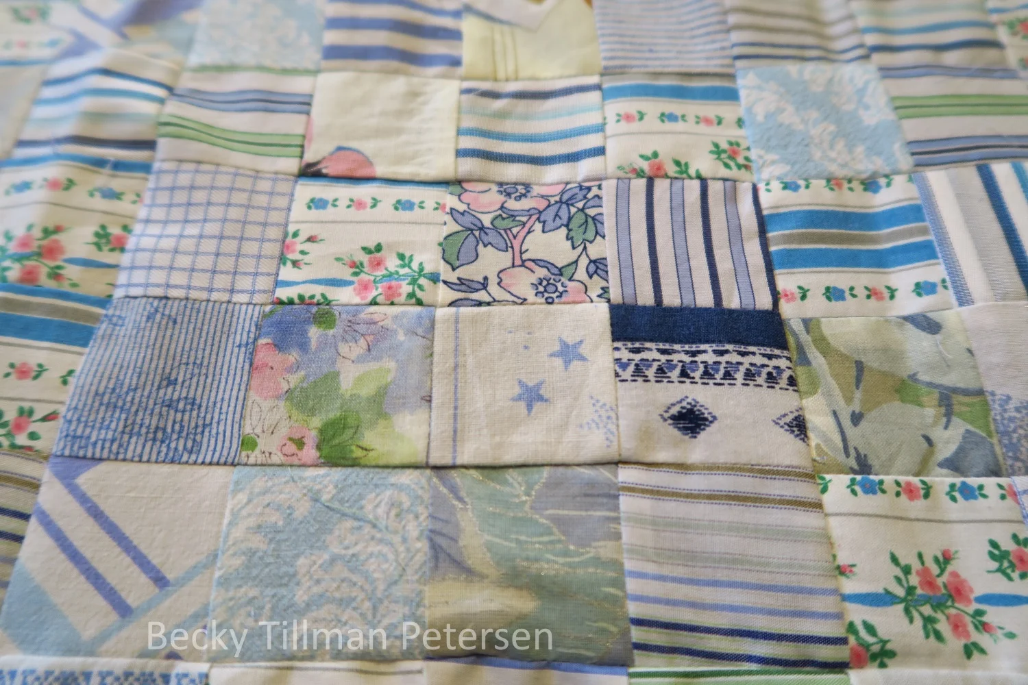 A close up of the squares. When choosing fabrics for this one, I looked for things with a white or off white background - I tried to stay away from tan or light yellow background- though there are some fuzzy gray areas with that interpretation. In the end, it's my quilt - I can put whatever fabrics I wanted to in it! 