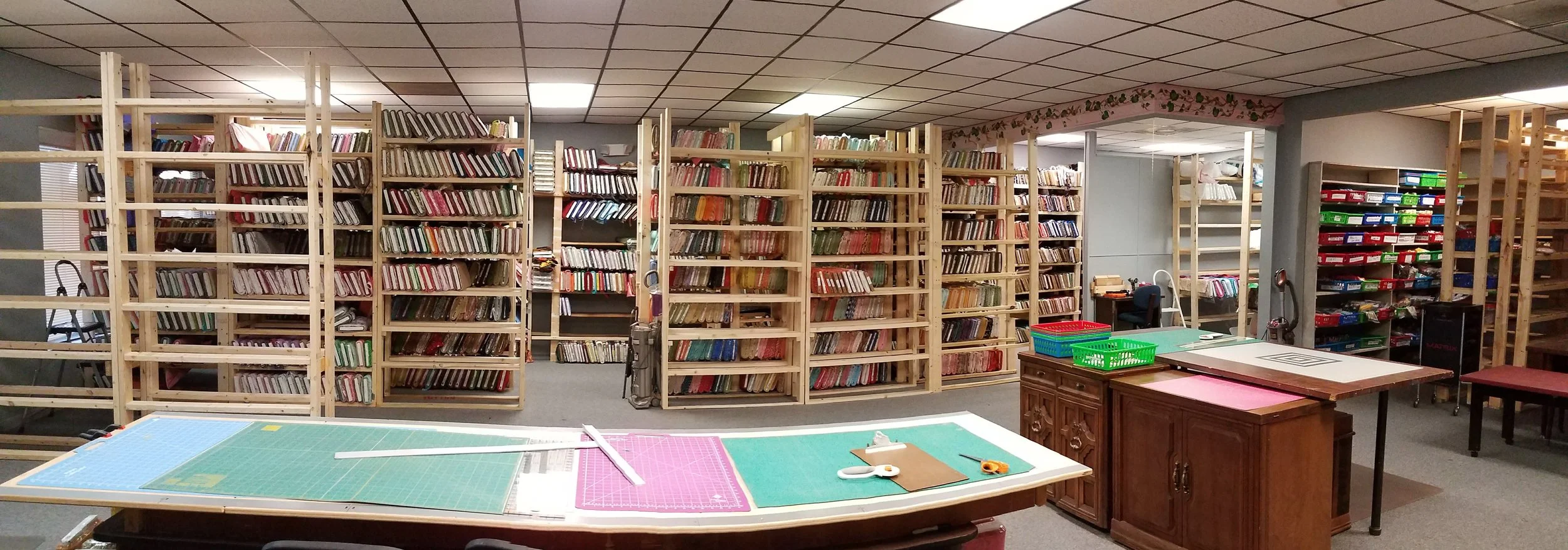 It's awesome now! It's not done, but it's great! We have shelves for the fabrics that we have ready and two cutting tables!