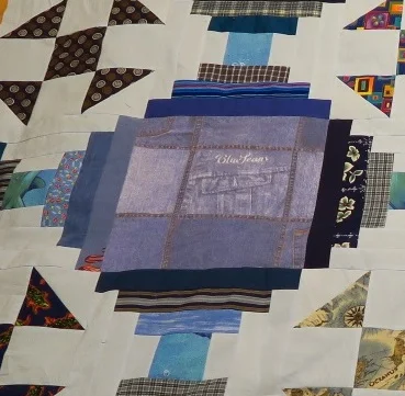 This blue fabric square is the same fabric that I used for the lighter chain in this quilt. It was a duvet cover so I had quite a bit of fabric in it.