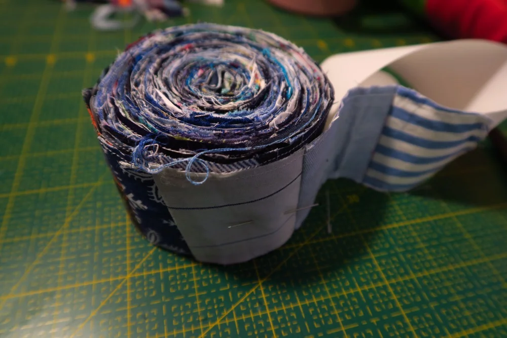 My roll looks like this. I can do this kind of sewing when I'm pretty tired as it doesn't involve anything technical or really any decisions about anything. Just put a piece on and go on. No worries about color, half square triangles, measuring, or anything.
