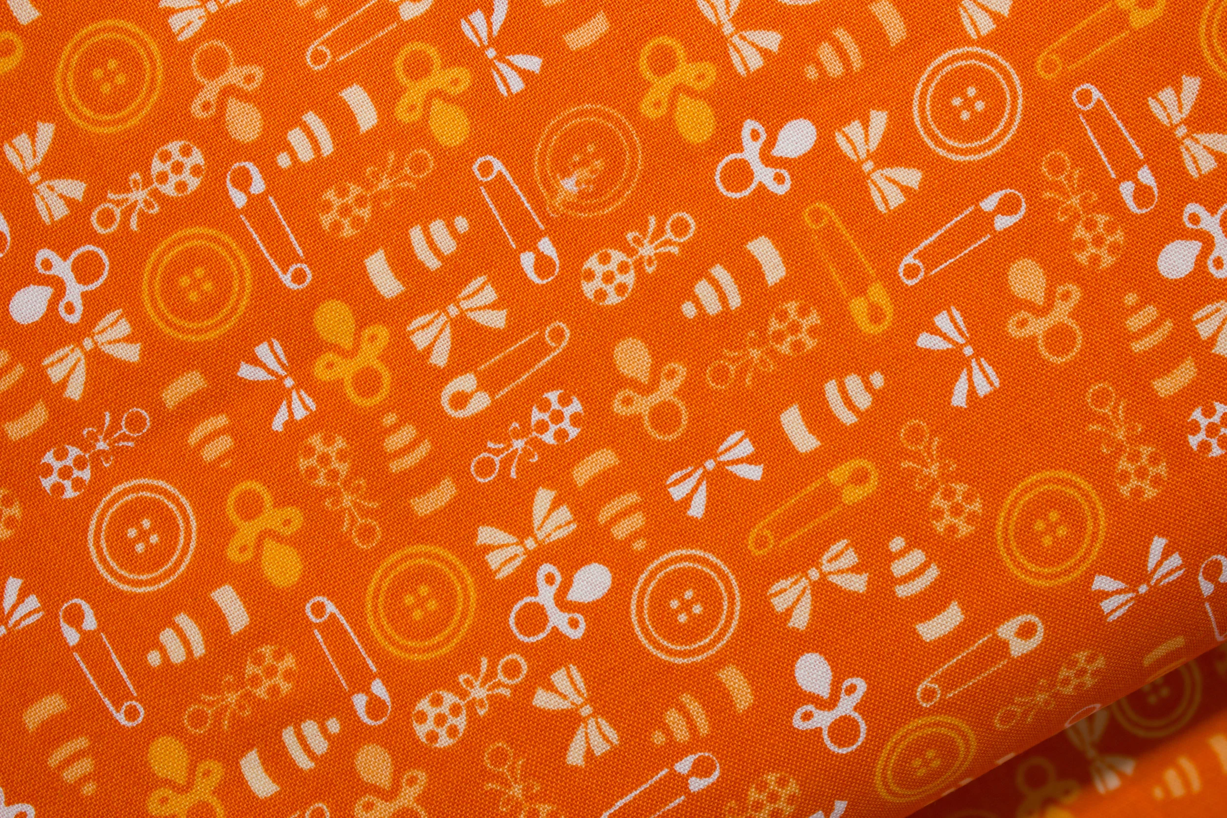 Baby Talk: Orange Pacifiers and Rattles on Orange
