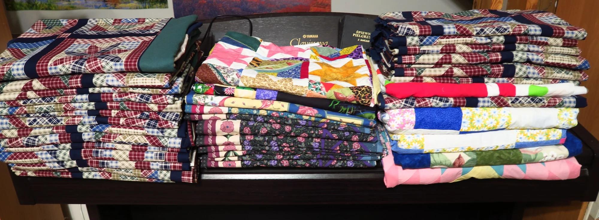 These are tops that my sis and I prepared last summer when she was here. There are a lot of panels here and cheater quilt fabric that I made into panels for the men, especially, since they are the dark colors that they seem to like.