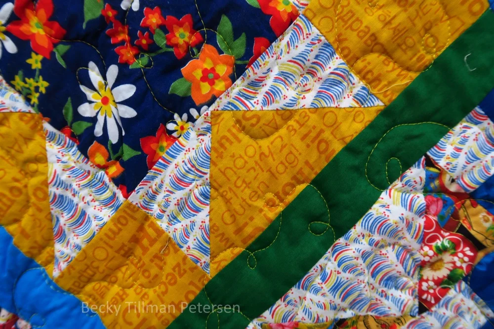 Here's a nice closeup of the Riley Blake yellow fabric with foreign words on it. The theme of this being for my friends who are here in Poland is throughout this quilt!