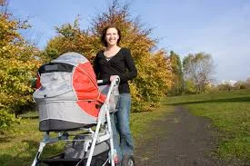Polish woman pushing baby cart in Poland