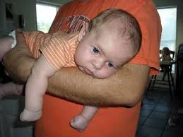 Petersen baby being held on stomach opposed to Polish culture.