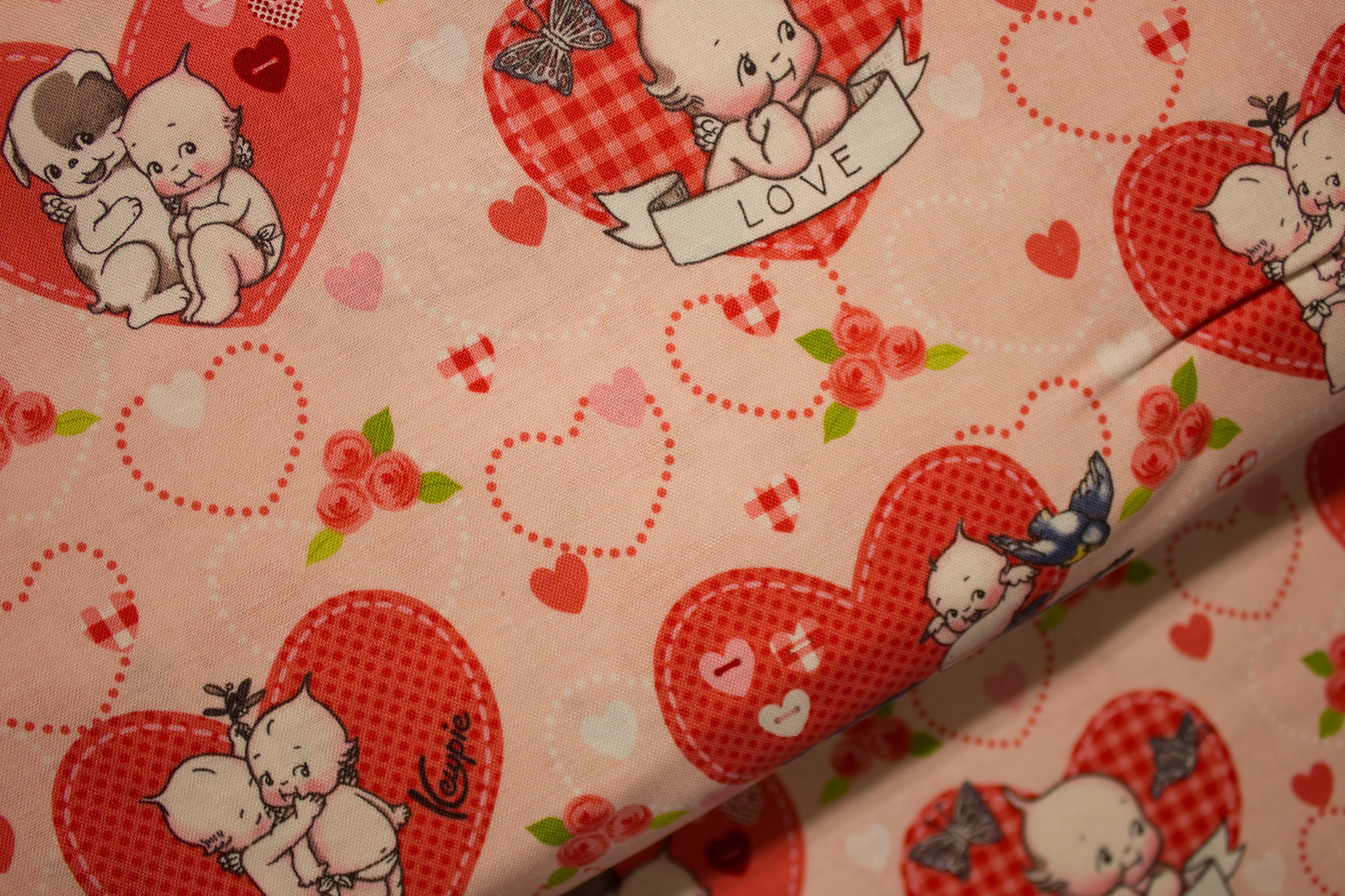 Kewpids Sitting on Birds and Other Scenes, on Light Pink - Kewpie Cuties for Riley Blake