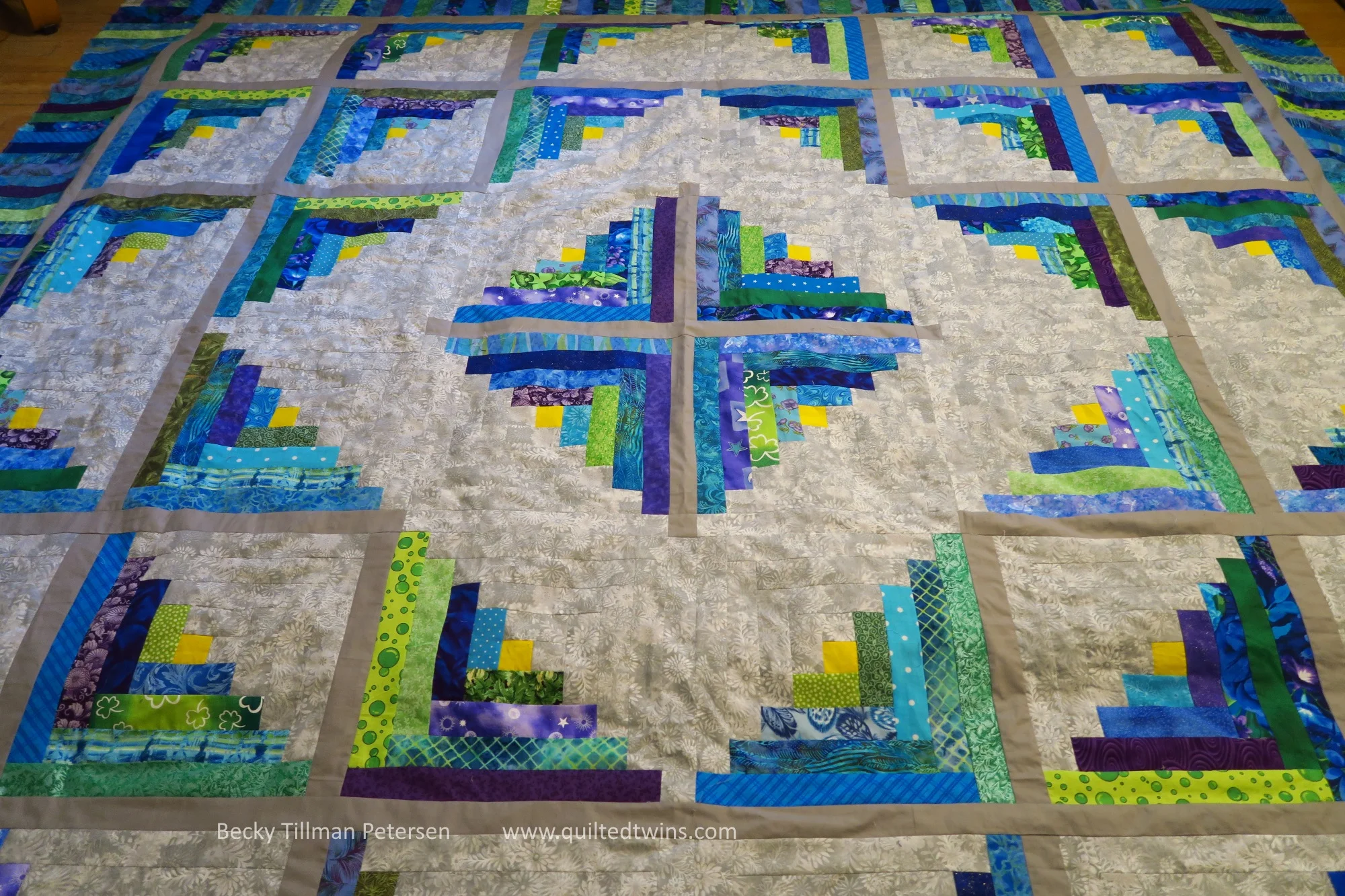 "Cabin Fever Blues" in purples, blues, greens and gray top finished