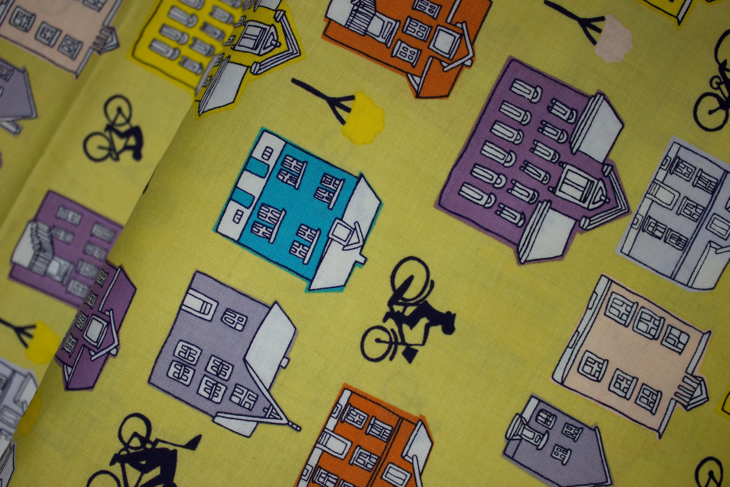 Ride by Windham Fabrics by Julia Rothman - Bicycle Rider and Houses on Yellow discount quilting fabric