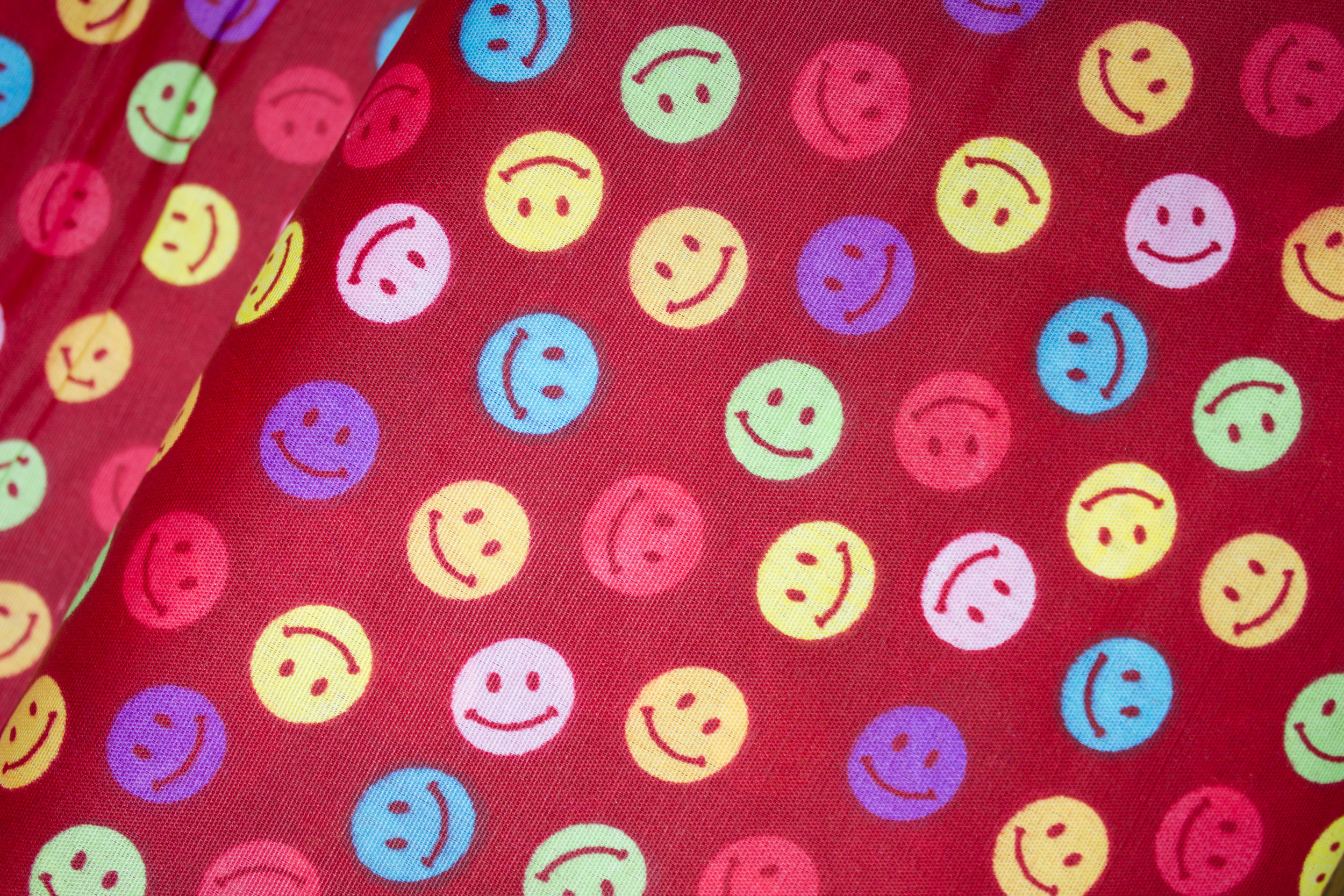 Smiley Stickers on Dark Red discount quilting fabric