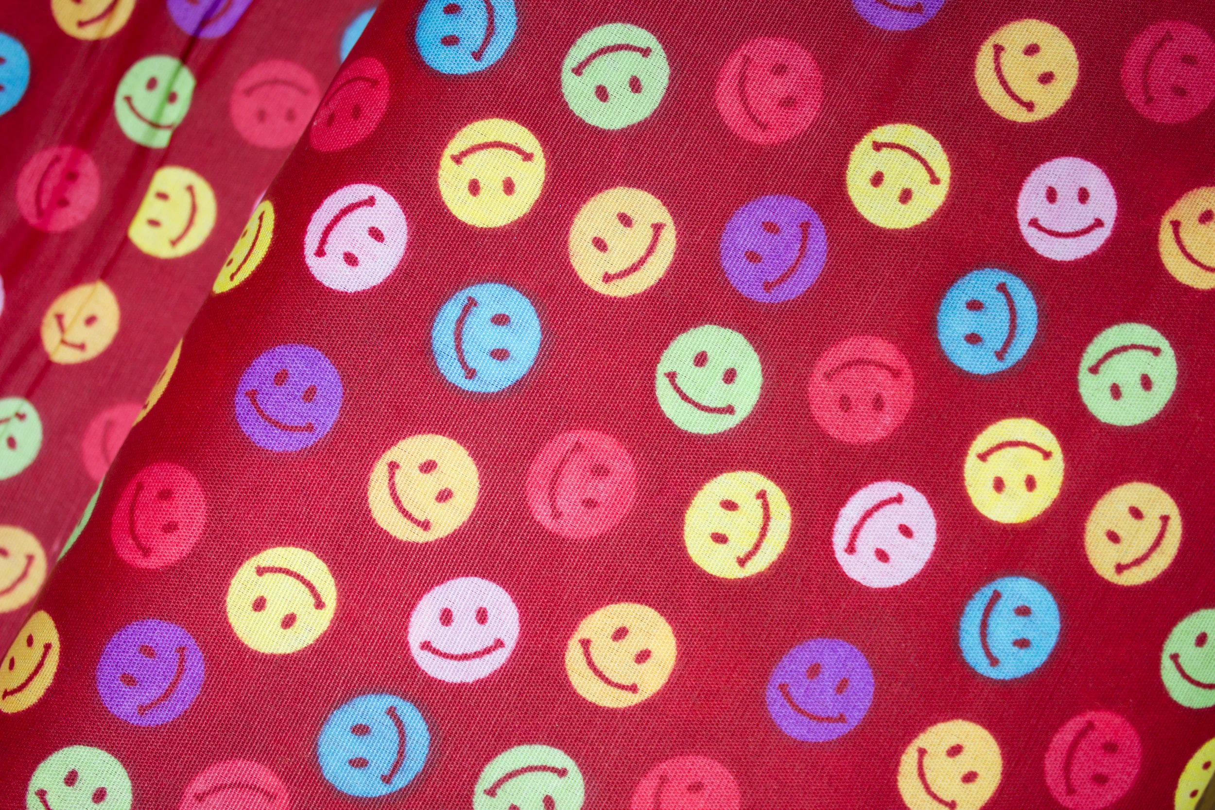 Smiley Stickers on Dark Red - This is a poly/cotton blend