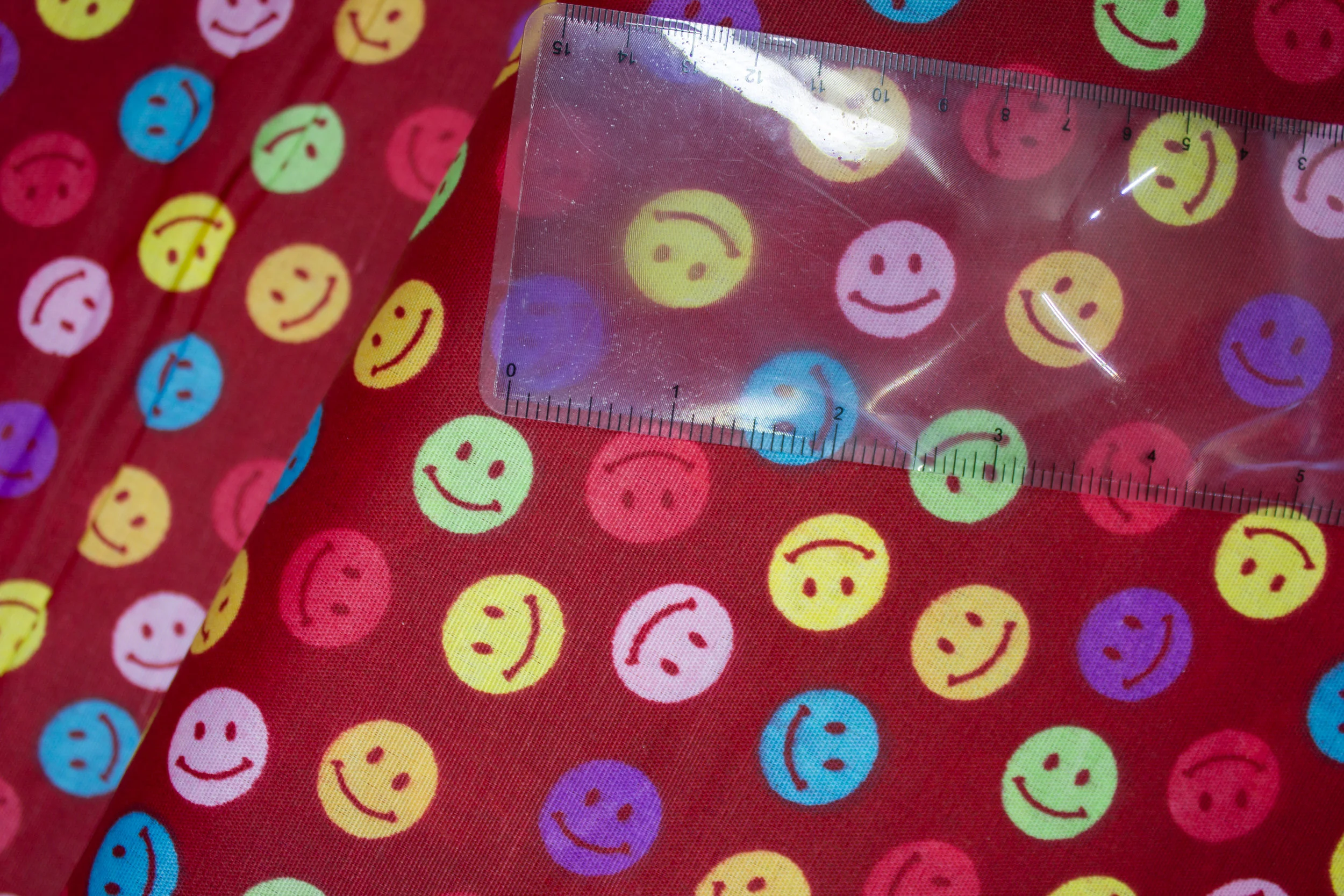 Smiley Stickers on Dark Red discount quilting fabric