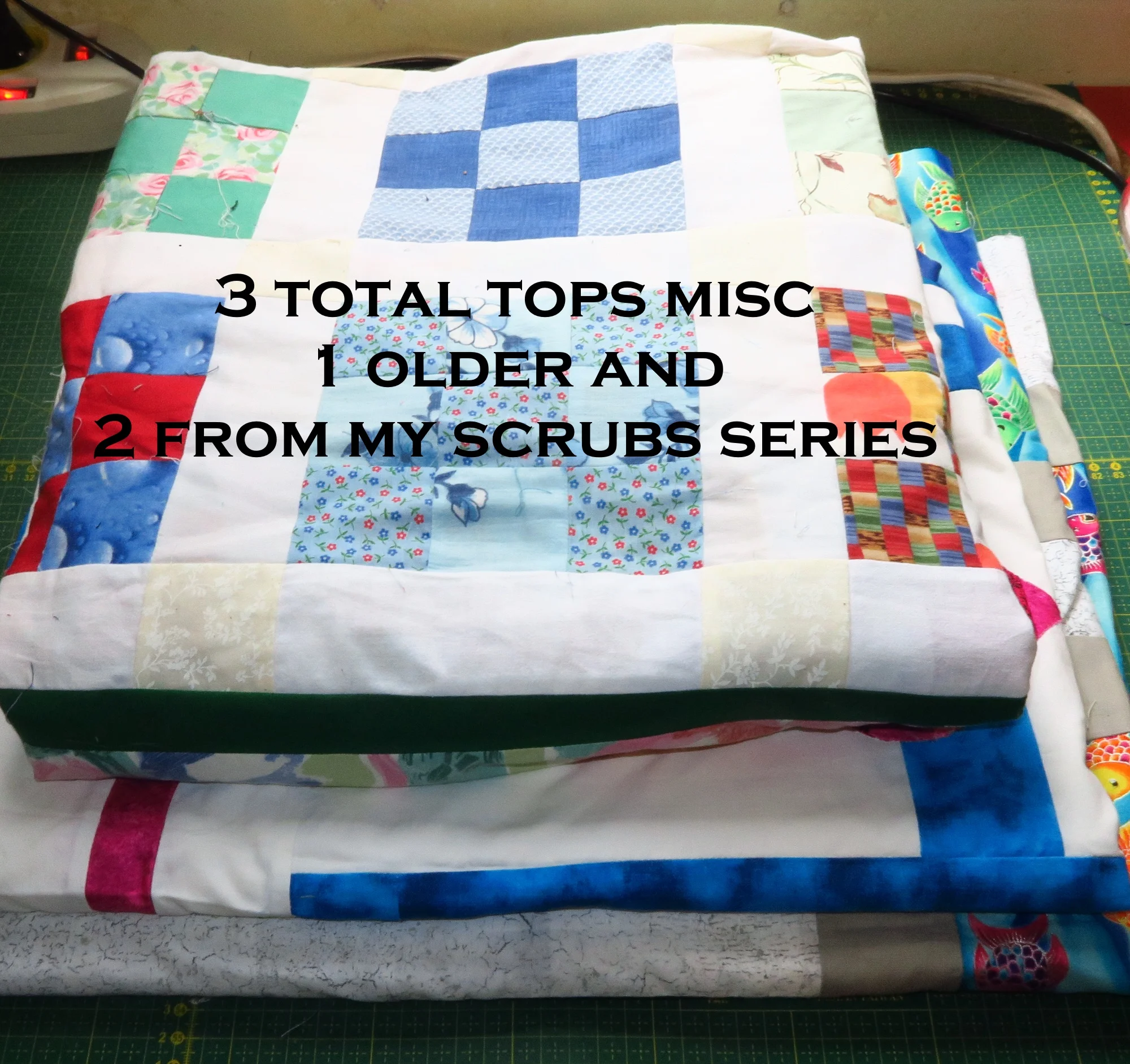 the top one is a simple 9 patch scrappy with a wide border - and the bottom two are from my scrubs fabrics series. 3 tops.