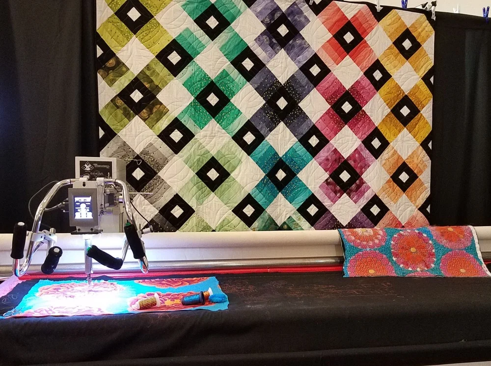 While I was playing on the longarm, my husband was checking out the other one, also being demonstrated by another staff member.