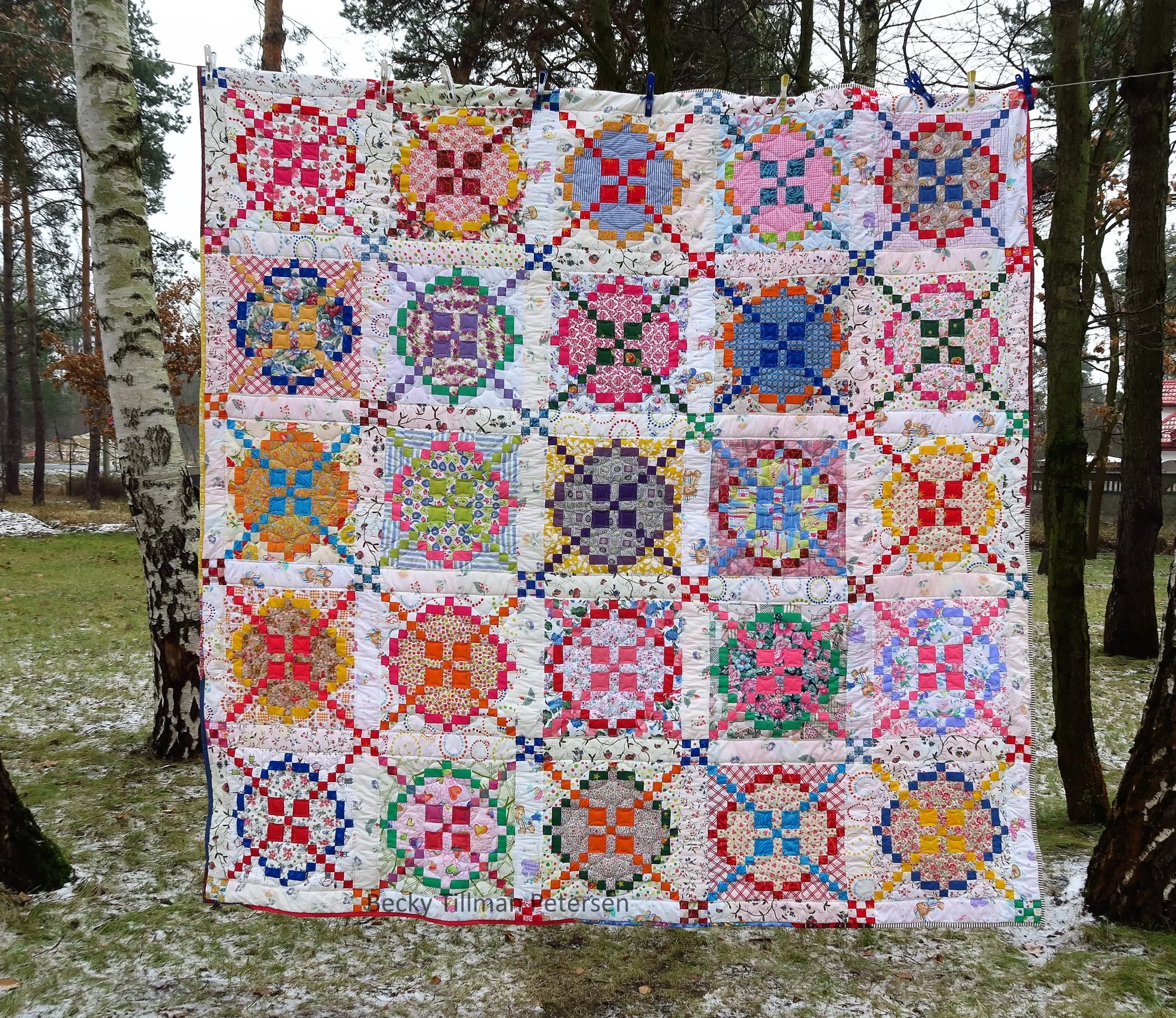 Design - classic Burgoyne Surrounded block Inspired by - wanting to make a light and airy one as I had made a couple of this pattern before in a civil war look - tans, browns, dark reds, etc. I opted for pretty, fun, light-hearted. I checked out several blogs. I made it as a quilt along in a Facebook group I am in. Regrets - This 100% upcycled quilt has a few spots where I could have been more careful choosing the fabrics. I noticed while quilting, for example, that one or two of the pieces had a buttonhole slit in it. I don’t know why I didn’t notice that while piecing. I had to quilt over the buttonhole and make sure that it was no more! Normally I didn’t keep the section of blouses where the buttonholes were but we had bought some second hand fabrics from a lady back in 2015 and she “very carefully” took all the blouses apart and ironed everything! I generally don’t keep that section of the shirt and definitely don’t bother to work with that kind of finesse when de-constructing a shirt.