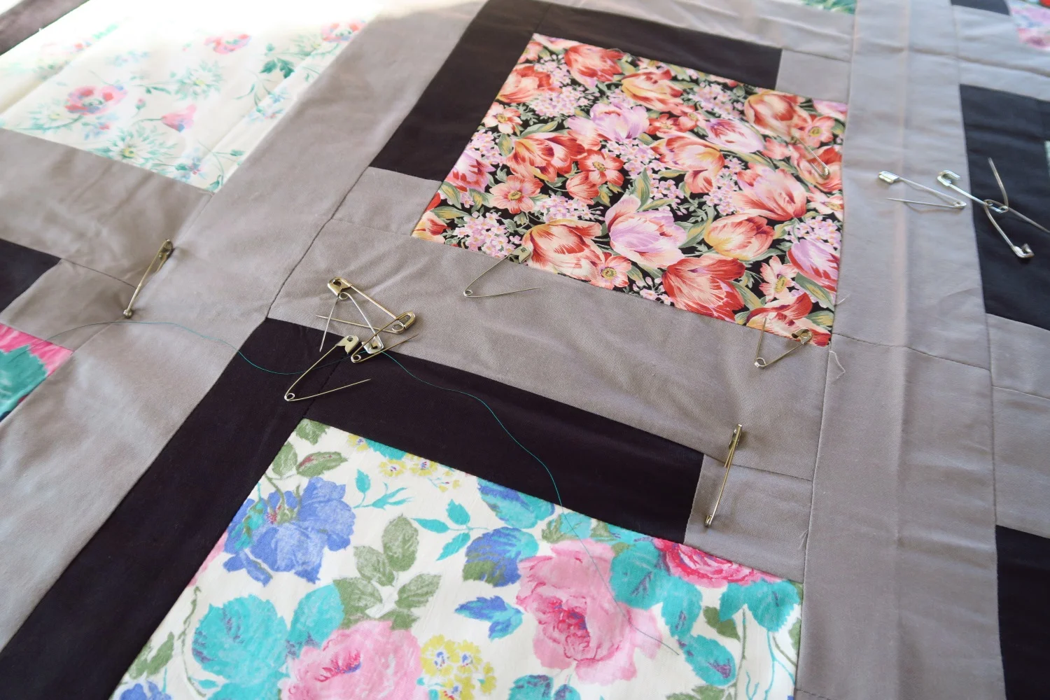 Sandwiching all these charity quilt tops!