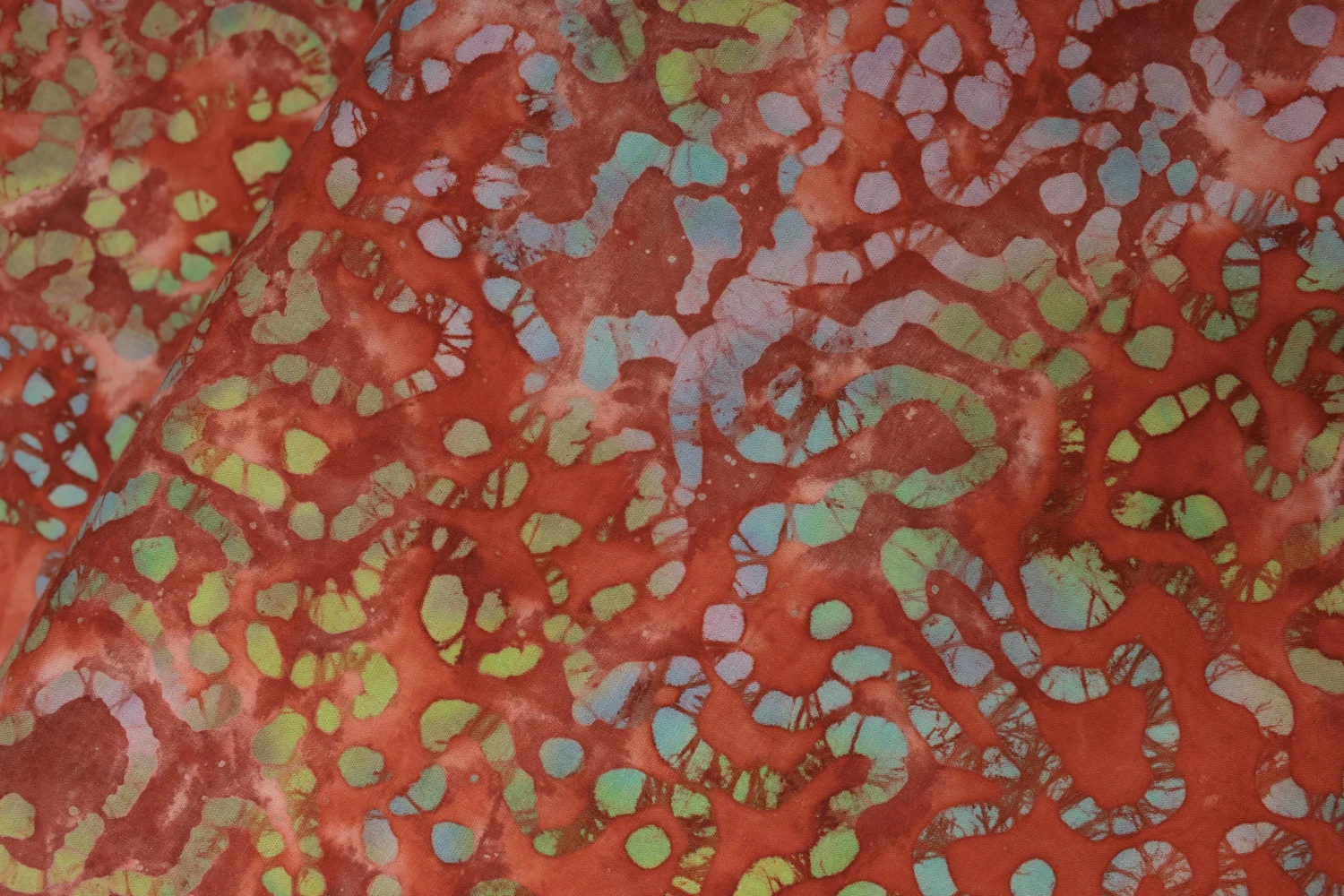 Red with Green, Blue, and Periwinkle Meandering Dotted Line: Quilter's Batiks