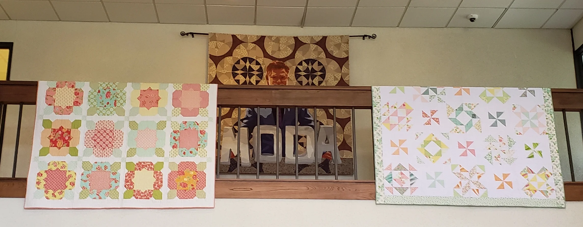 These were in the lobby - the quilt in the middle is Mr. Dunn, the founder of Moda Fabrics.